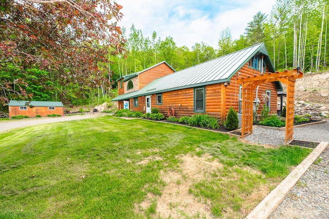 15 Doe Cir, Bingham, ME 04920 - view of front facade with a front yard, metal roof, a standing seam roof, and faux log siding