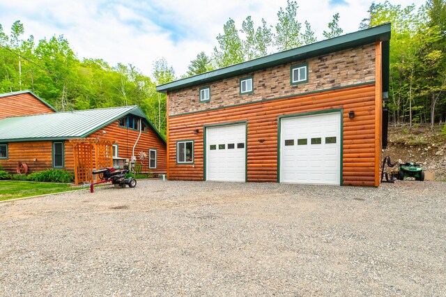 15 Doe Cir, Bingham, ME 04920 - view of front of home with driveway and log veneer siding