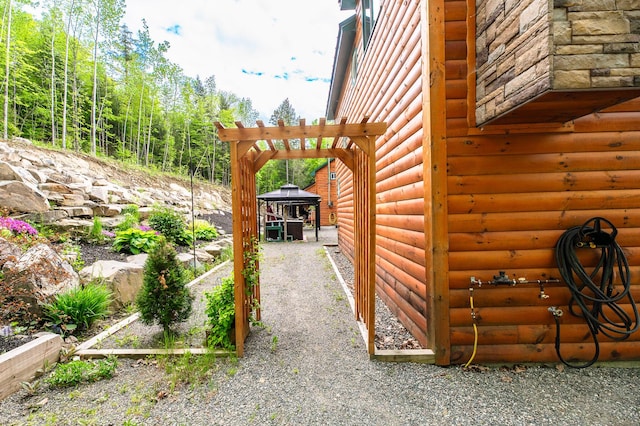 15 Doe Cir, Bingham, ME 04920 - view of side of property featuring log veneer siding and a gazebo