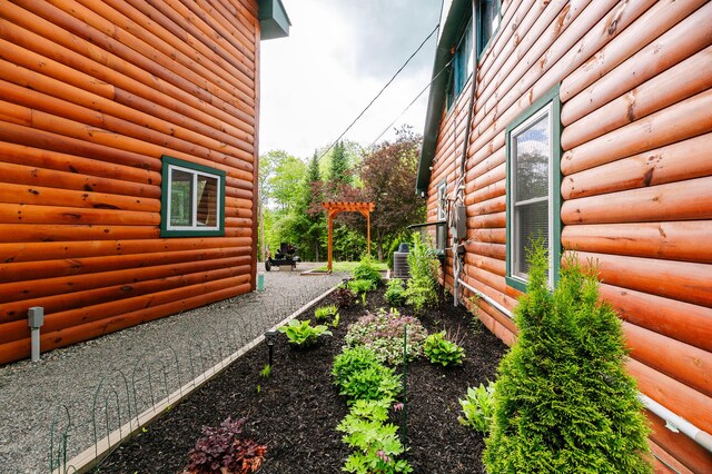 15 Doe Cir, Bingham, ME 04920 - view of side of home featuring log veneer siding and central air condition unit