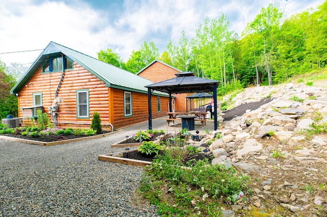 15 Doe Cir, Bingham, ME 04920 - rear view of house with a patio, central air condition unit, a gazebo, metal roof, and faux log siding