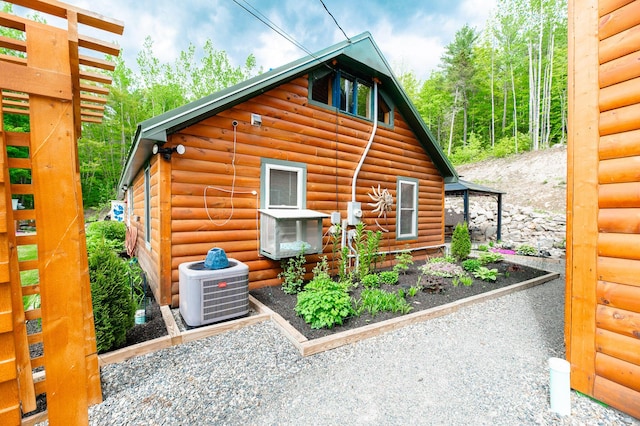 15 Doe Cir, Bingham, ME 04920 - view of home's exterior with faux log siding and central air condition unit