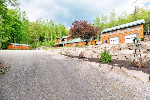 15 Doe Cir, Bingham, ME 04920 - view of front of home with roof mounted solar panels and driveway
