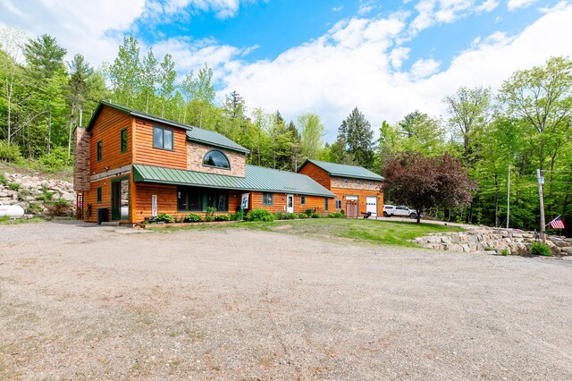 15 Doe Cir, Bingham, ME 04920 - view of front of property featuring metal roof, covered porch, and log veneer siding