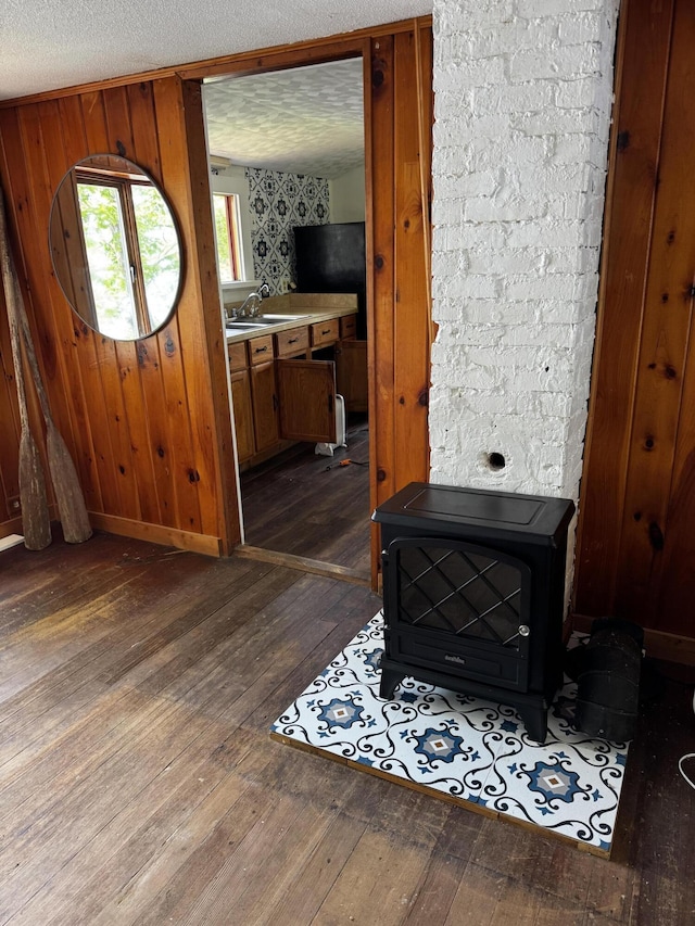 46 Arrowsic Rd, Arrowsic, ME 04530 - foyer entrance featuring dark wood finished floors, a textured ceiling, and a wood stove