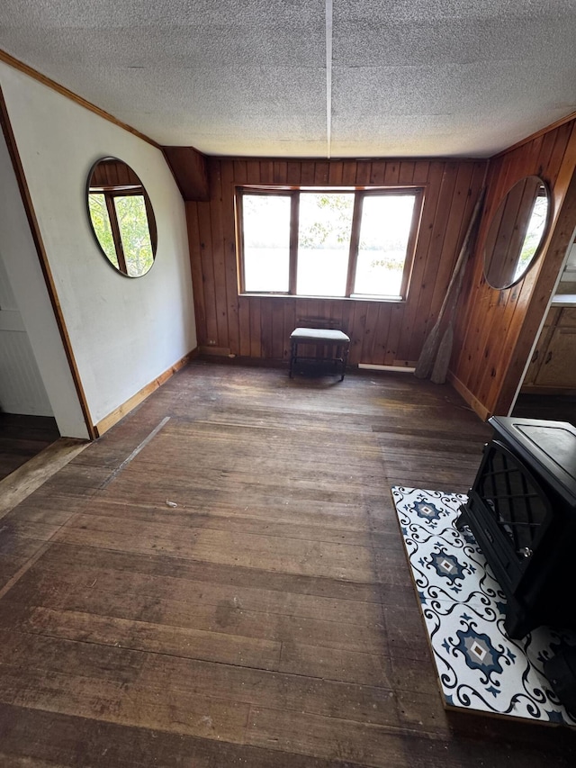 46 Arrowsic Rd, Arrowsic, ME 04530 - bedroom with dark wood-type flooring, wooden walls, baseboards, and a textured ceiling