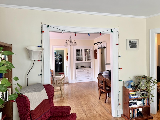 91 Washburn Ave, Portland, ME 04102 - living area featuring ornamental molding, light wood-style floors, and a chandelier