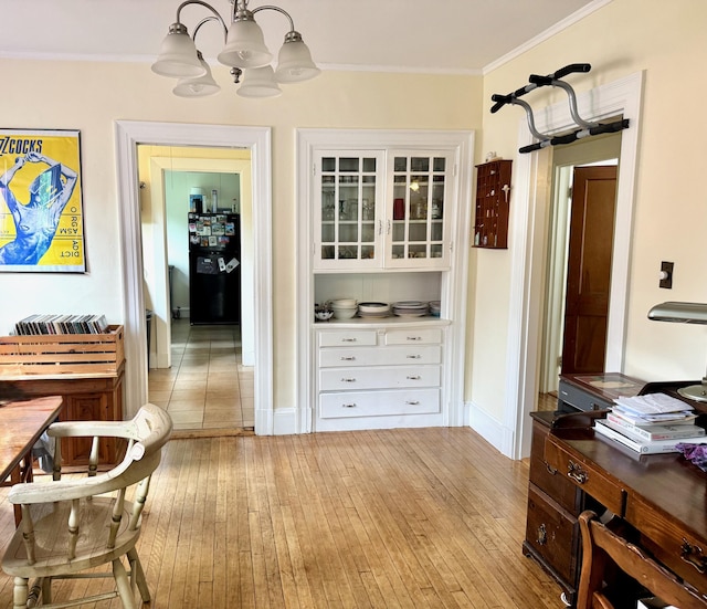 91 Washburn Ave, Portland, ME 04102 - dining area featuring light wood-style floors, a chandelier, ornamental molding, and baseboards