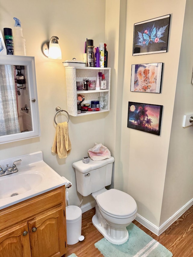 91 Washburn Ave, Portland, ME 04102 - full bathroom with toilet, wood finished floors, vanity, baseboards, and a shower with curtain