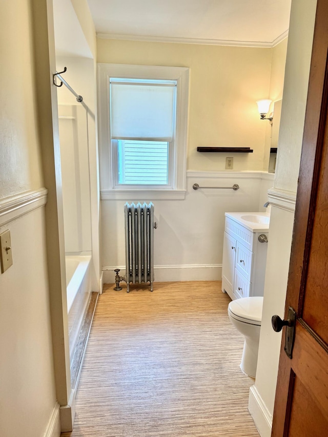 91 Washburn Ave, Portland, ME 04102 - full bathroom with radiator, vanity, crown molding, toilet, and shower / tub combination