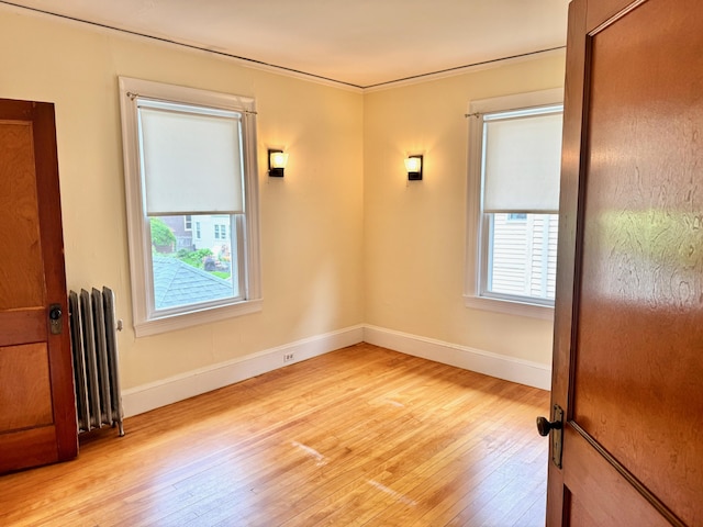91 Washburn Ave, Portland, ME 04102 - unfurnished room featuring radiator, light wood-style floors, and baseboards