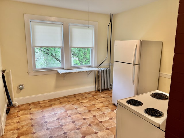 91 Washburn Ave, Portland, ME 04102 - kitchen featuring radiator, white appliances, light floors, baseboards, and light countertops