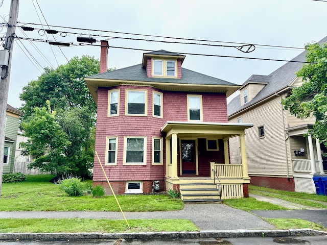 91 Washburn Ave, Portland, ME 04102 - american foursquare style home featuring covered porch, a chimney, a front lawn, and a shingled roof
