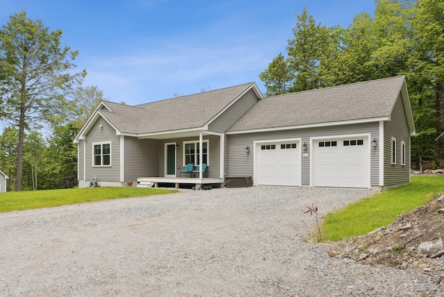 LOT10 Foye Rd, Wiscasset, ME 04578 - ranch-style house with gravel driveway, a garage, roof with shingles, and a porch