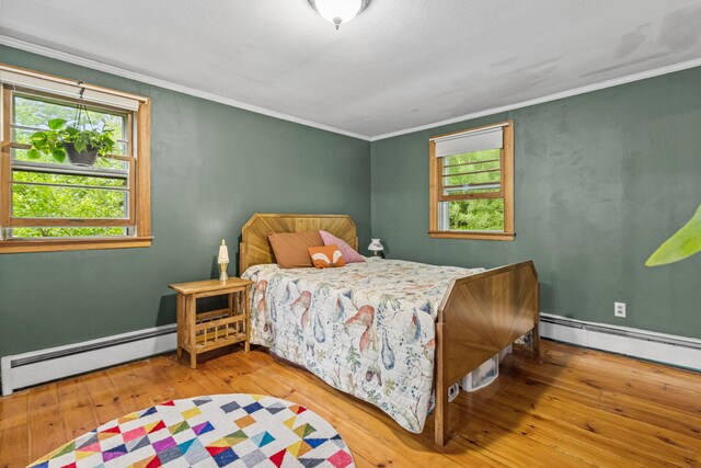 153 Shaker Rd, Gray, ME 04039 - bedroom featuring a baseboard radiator, multiple windows, wood-type flooring, and crown molding