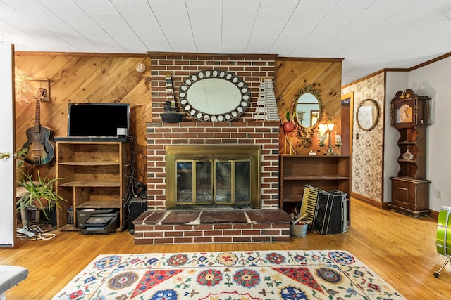153 Shaker Rd, Gray, ME 04039 - unfurnished living room with wood finished floors, crown molding, wooden walls, a fireplace, and baseboards