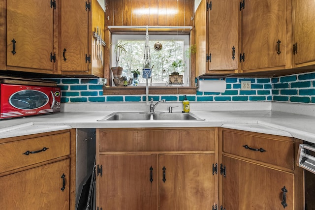 153 Shaker Rd, Gray, ME 04039 - kitchen featuring light countertops, decorative backsplash, a sink, brown cabinets, and dishwashing machine