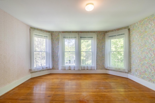 10 Joslyn St, Newport, ME 04953 - spare room featuring wallpapered walls, wood finished floors, and baseboards