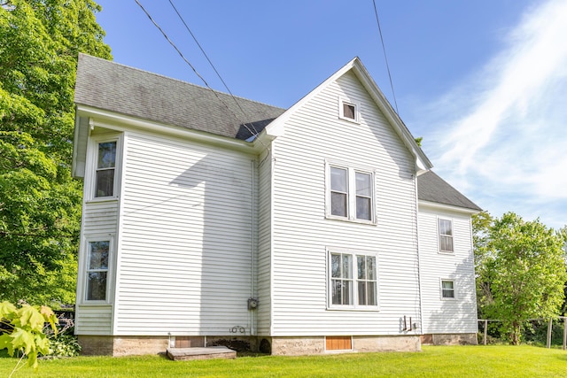 10 Joslyn St, Newport, ME 04953 - back of property with a yard and roof with shingles