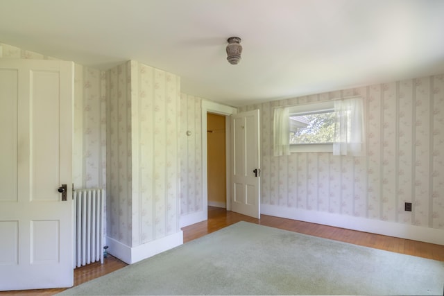 10 Joslyn St, Newport, ME 04953 - unfurnished bedroom with radiator heating unit, wood finished floors, and baseboards