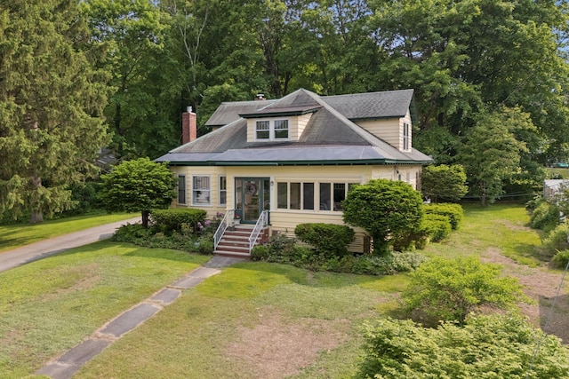 7 Carroll Ave, Auburn, ME 04210 - bungalow-style home featuring a front yard and a chimney