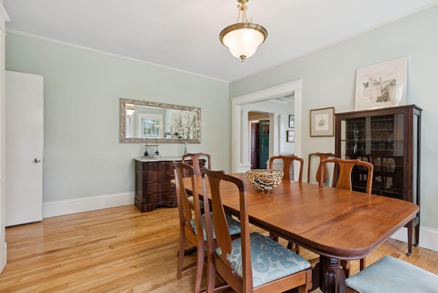 7 Carroll Ave, Auburn, ME 04210 - dining area with light wood-type flooring, crown molding, and baseboards