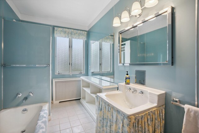 7 Carroll Ave, Auburn, ME 04210 - full bath with radiator, a tub to relax in, tile patterned floors, and vanity