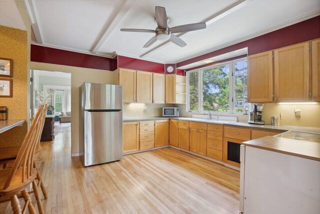 7 Carroll Ave, Auburn, ME 04210 - kitchen with appliances with stainless steel finishes, light brown cabinetry, plenty of natural light, light wood finished floors, and ornamental molding