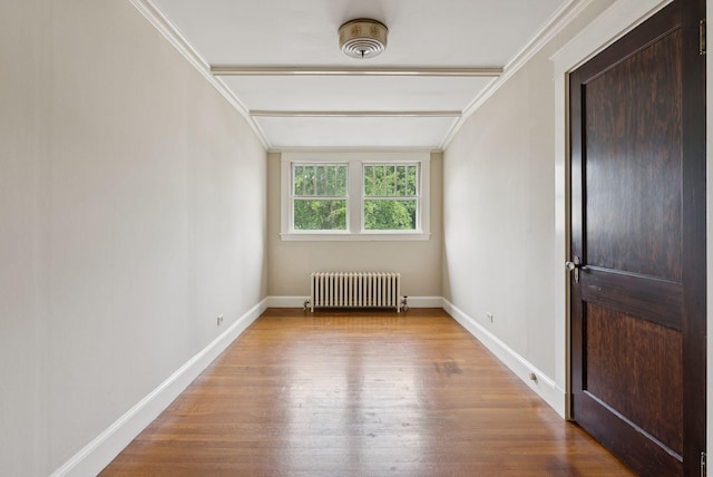 7 Carroll Ave, Auburn, ME 04210 - empty room with radiator heating unit, wood finished floors, baseboards, and crown molding