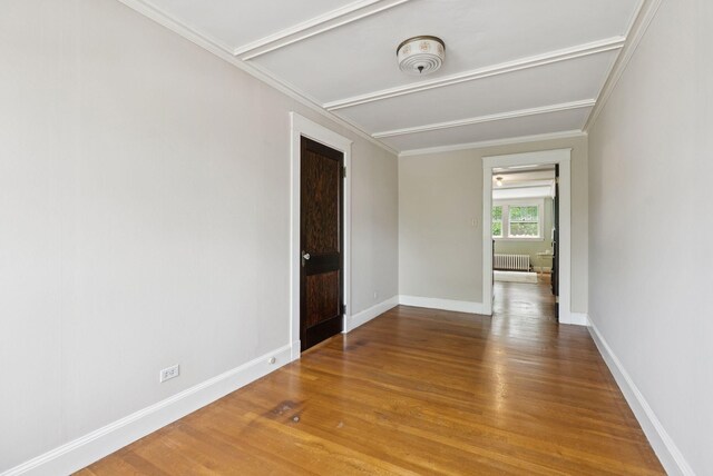 7 Carroll Ave, Auburn, ME 04210 - spare room with radiator heating unit, wood finished floors, baseboards, a smoke detector, and ornamental molding