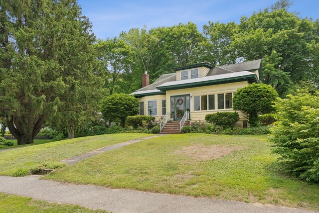 7 Carroll Ave, Auburn, ME 04210 - bungalow-style house with a front yard and a chimney
