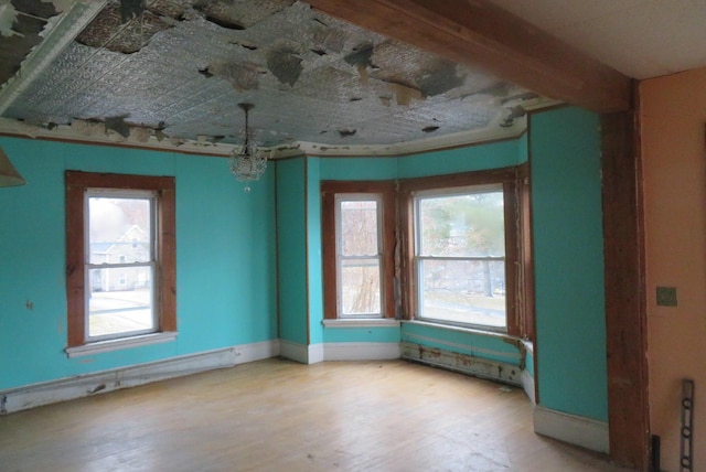 26 Walter St, Bangor, ME 04401 - unfurnished room with baseboard heating, plenty of natural light, and wood finished floors