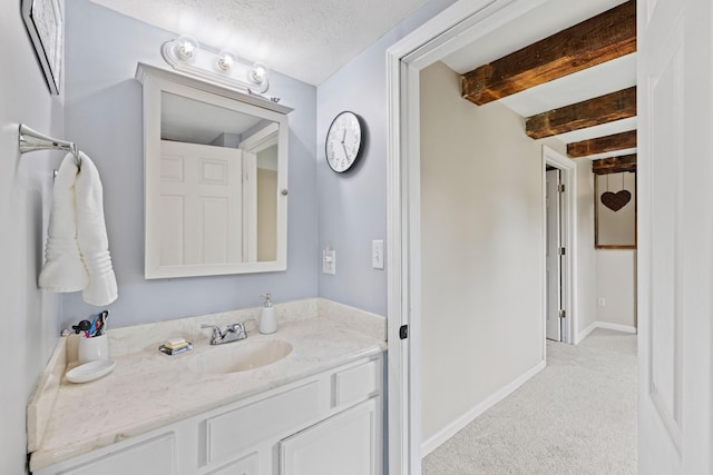 179 Alfred Rd, Kennebunk, ME 04043 - bathroom featuring beam ceiling and vanity