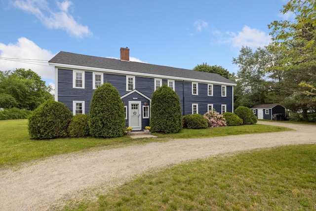 179 Alfred Rd, Kennebunk, ME 04043 - colonial inspired home featuring a chimney, a front yard, driveway, and a storage shed
