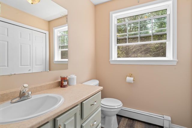 20 Huntington Ln, Berwick, ME 03901 - half bath with a baseboard heating unit, toilet, vanity, and wood finished floors