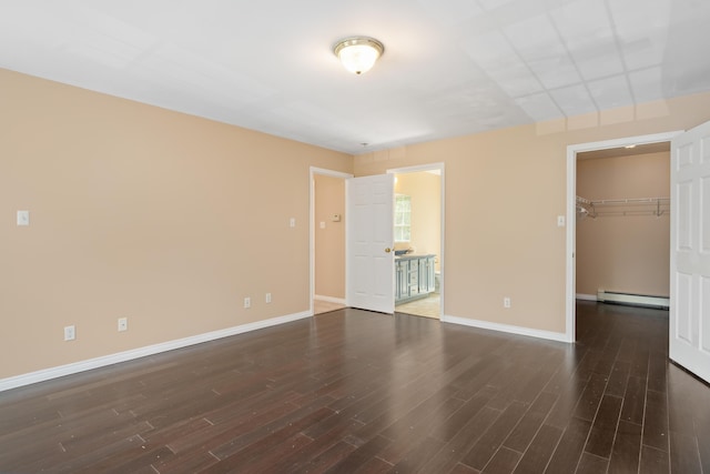 20 Huntington Ln, Berwick, ME 03901 - unfurnished bedroom featuring baseboard heating, wood finished floors, baseboards, and a walk in closet