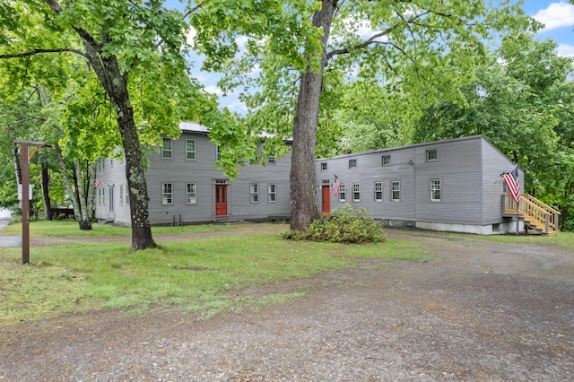 74 Main St, Cornish, ME 04020 - view of front of house featuring a front yard and view of scattered trees