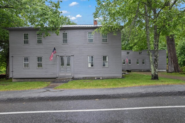 74 Main St, Cornish, ME 04020 - colonial house featuring a chimney and a front lawn