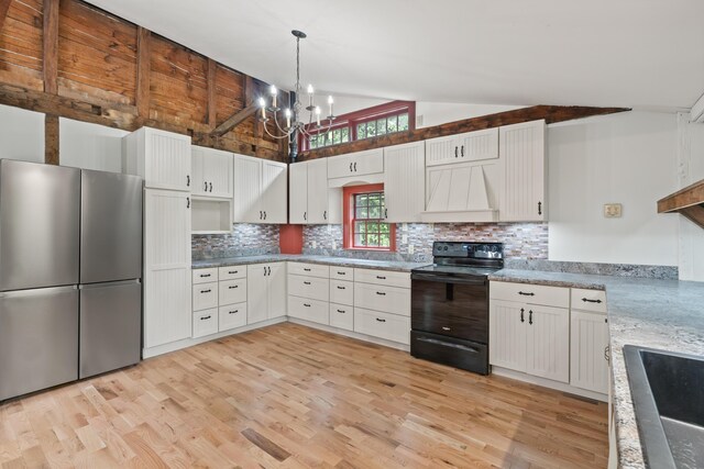 74 Main St, Cornish, ME 04020 - kitchen featuring black / electric stove, freestanding refrigerator, vaulted ceiling, light wood-type flooring, and backsplash