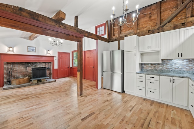 74 Main St, Cornish, ME 04020 - kitchen with freestanding refrigerator, a chandelier, tasteful backsplash, light wood-style flooring, and open shelves