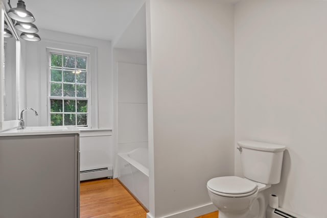 74 Main St, Cornish, ME 04020 - full bath featuring a baseboard radiator, vanity, toilet, and wood finished floors