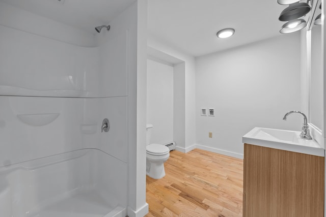 74 Main St, Cornish, ME 04020 - bathroom featuring a shower stall, toilet, wood finished floors, vanity, and a baseboard heating unit