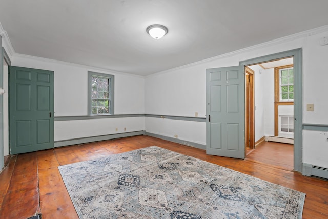 74 Main St, Cornish, ME 04020 - spare room featuring baseboard heating, wood-type flooring, crown molding, and baseboards