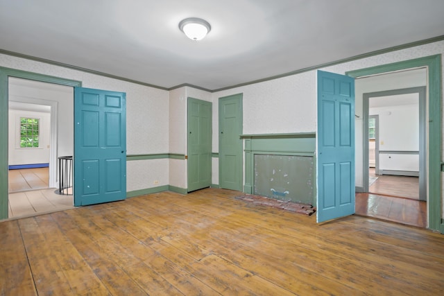 74 Main St, Cornish, ME 04020 - unfurnished living room featuring crown molding, a baseboard radiator, and hardwood / wood-style floors