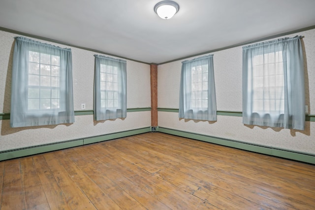 74 Main St, Cornish, ME 04020 - empty room featuring ornamental molding, healthy amount of natural light, hardwood / wood-style flooring, baseboard heating, and wallpapered walls