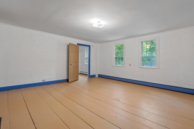 74 Main St, Cornish, ME 04020 - unfurnished room with a baseboard radiator and light wood-style flooring