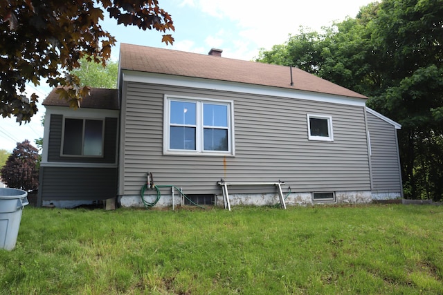 1 Chadwick St, Winslow, ME 04901 - view of side of home featuring a yard, a chimney, and roof with shingles