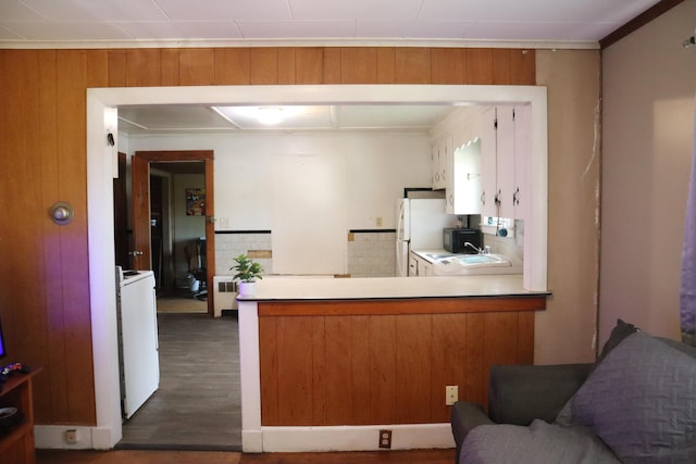 1 Chadwick St, Winslow, ME 04901 - kitchen with freestanding refrigerator, a peninsula, dark wood-type flooring, black microwave, and white cabinetry