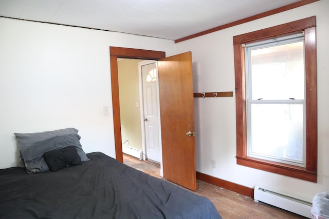1 Chadwick St, Winslow, ME 04901 - bedroom featuring a baseboard radiator, wood finished floors, and baseboards