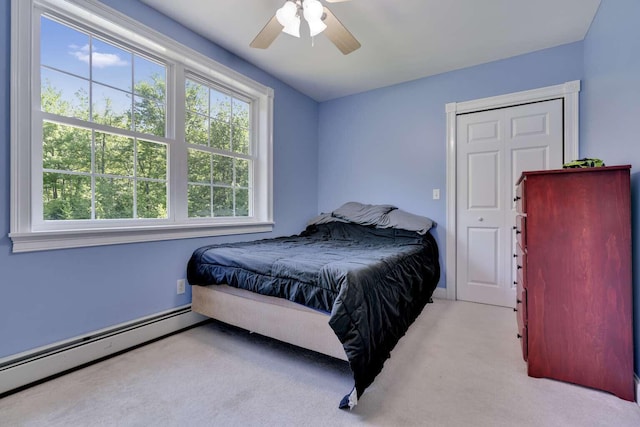 1505 Foxes Ridge Rd, Acton, ME 04001 - bedroom featuring multiple windows, a baseboard radiator, light carpet, and ceiling fan